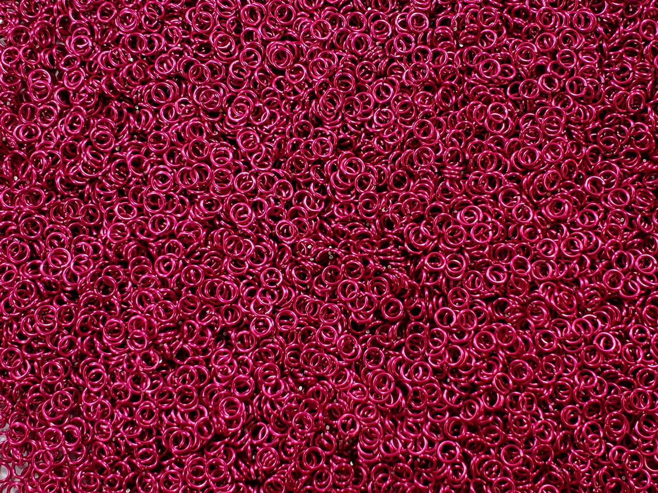 Cosmic Pink Anodized Aluminum jump rings in 20 SWG, 9/64 inch ID, 1/4 lb (4 oz)