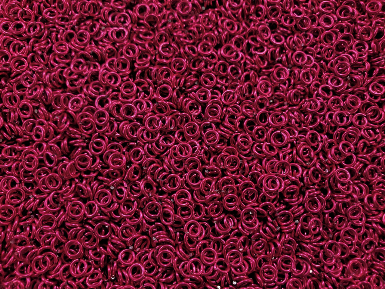 Cosmic Pink Anodized Aluminum jump rings in 18 SWG, 9/64 inch ID, 1/4 lb (4 oz)