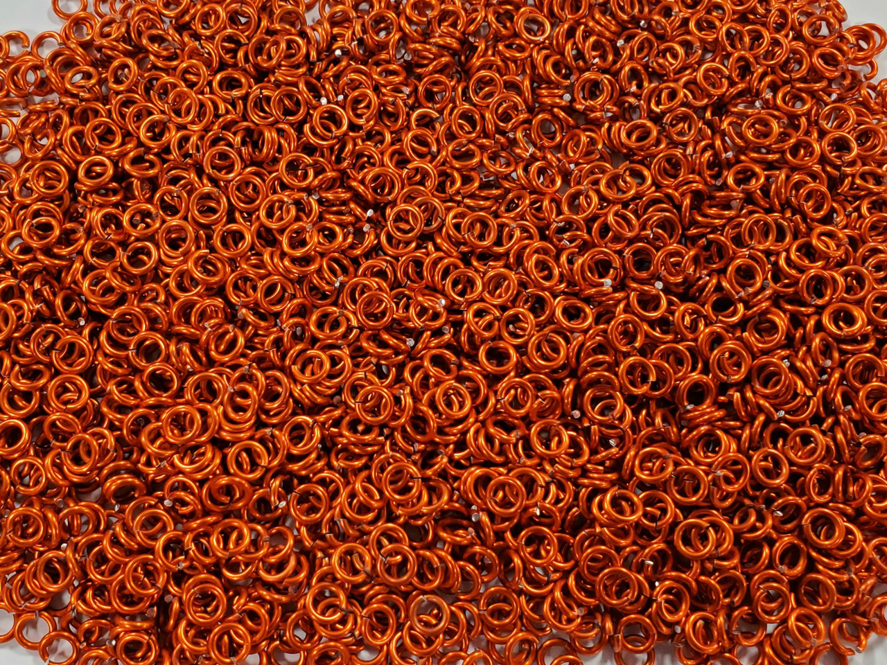 Orange Anodized Aluminum jump rings in 16 SWG, 3/16 inch ID, 1/2 lb (8 oz)