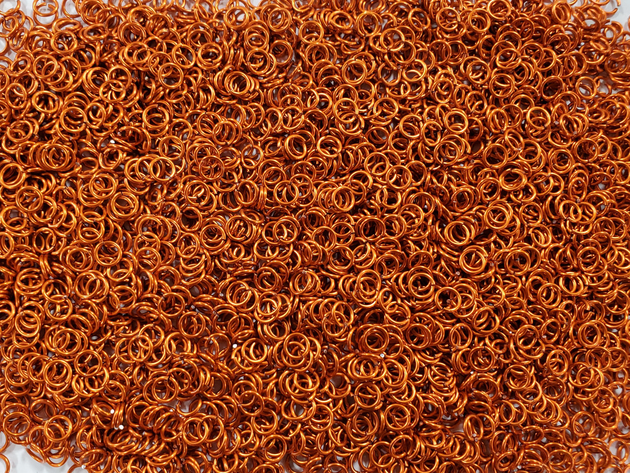 Orange Anodized Aluminum jump rings in 18 SWG, 7/32 inch ID, 1/2 lb (8 oz)