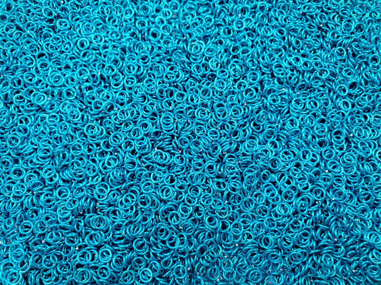 Turquoise Anodized Aluminum jump rings in 20 SWG, 9/64 inch ID, 1/4 lb (4 oz)