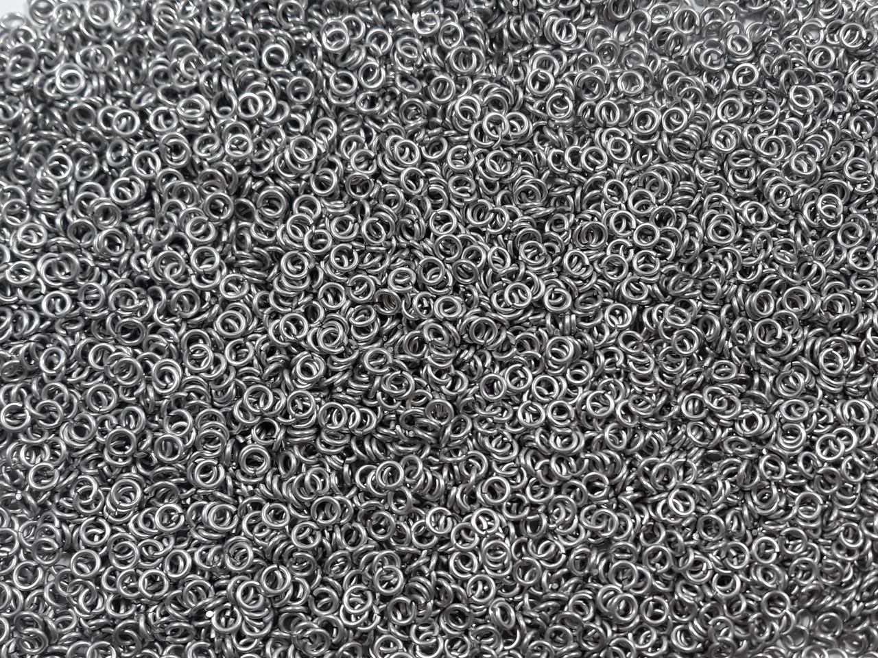 Silver Anodized Aluminum jump rings in 18 SWG, 9/64 inch ID, 1/4 lb (4 oz)