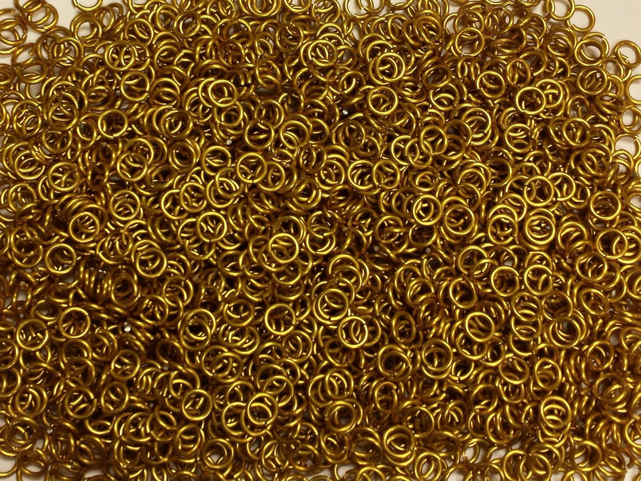 Gold Anodized Aluminum jump rings in 16 SWG, 1/4 inch ID, 1/2 lb (8 oz)