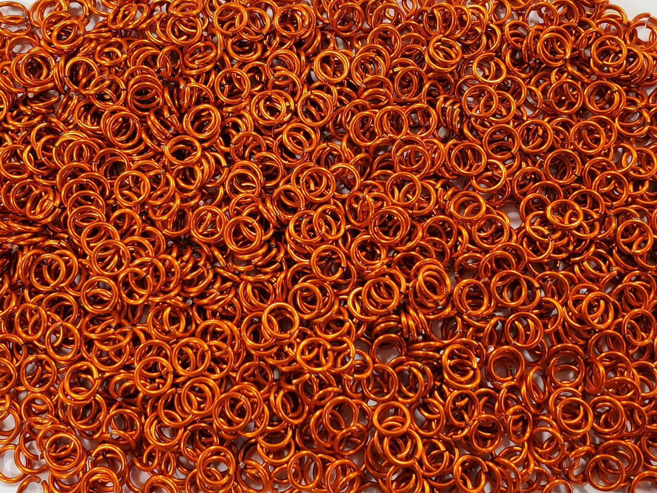 Orange Anodized Aluminum jump rings in 16 SWG, 9/32 inch ID, 1 oz