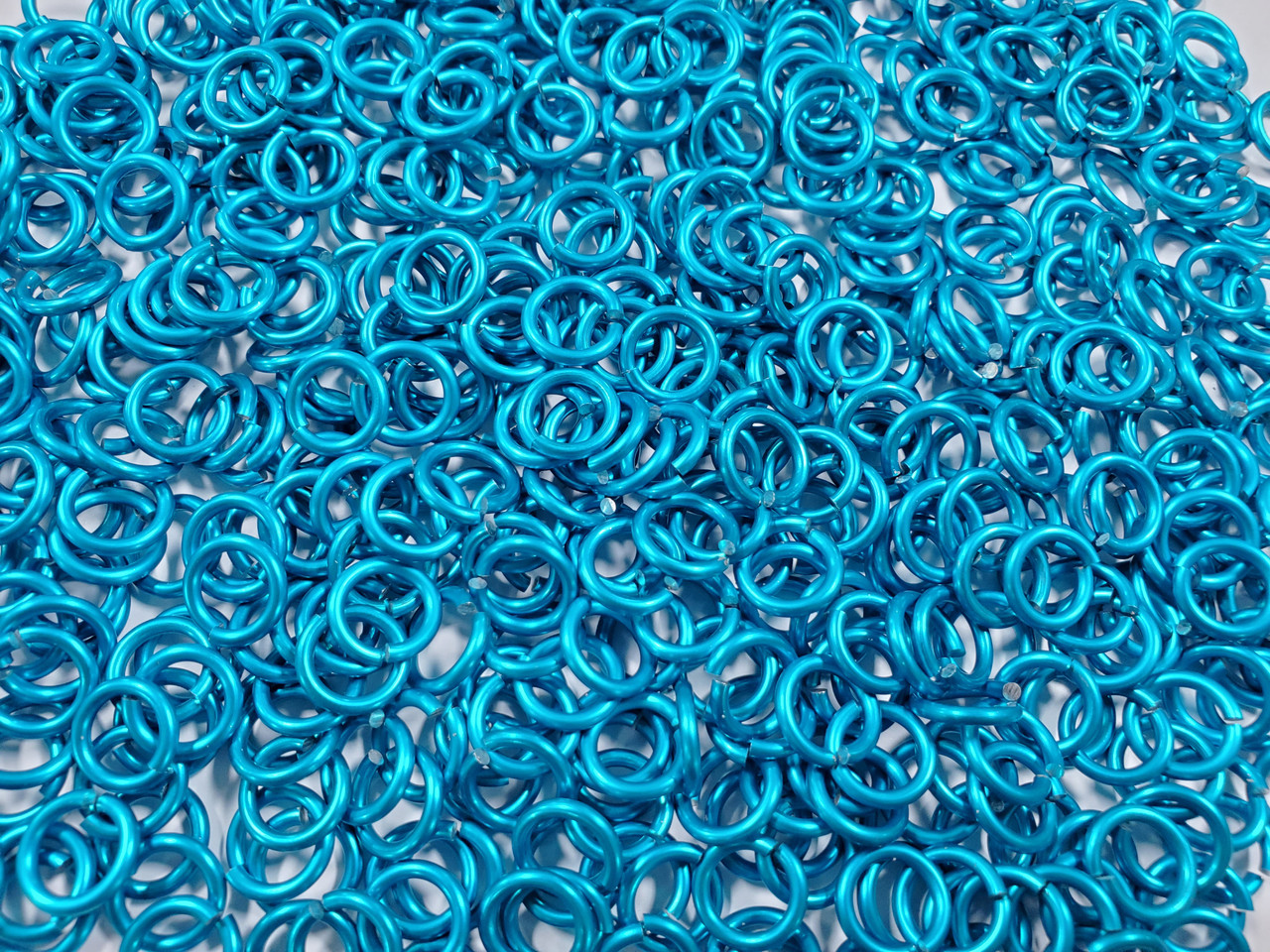Turquoise Anodized Aluminum jump rings in 14 SWG, 5/16 inch ID, 1 oz